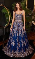 A woman stands indoors in the Gold-Sequin Navy Blue Long Prom Gown CM323, a floor-length, sleeveless dress adorned with stunning gold embroidery.