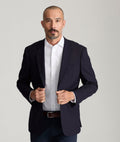 Model is wearing UNTUCKit Spencer shirt in white.