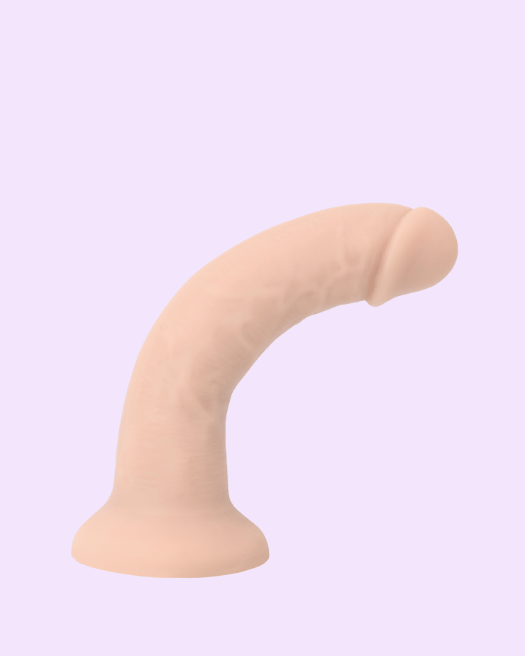 Beige | soft strap-on dildo showcasing flexible bend