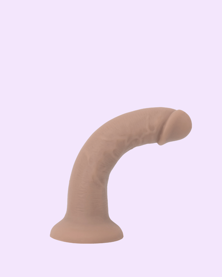 Tan | soft strap-on dildo showcasing flexible bend