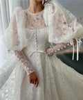 A Line white bridal dress with buttons, flowers and long sleeves