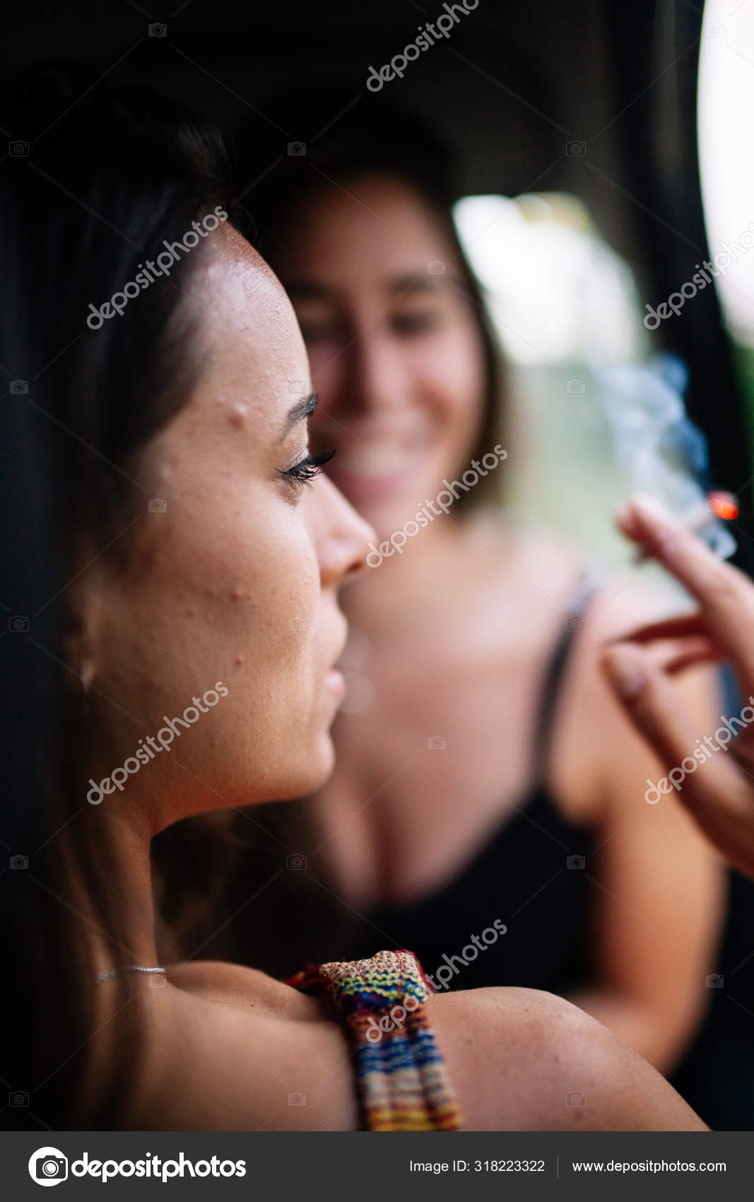 Two young lesbians smoking inside a car — Stock Photo © vientocuatroestudio  #318223322