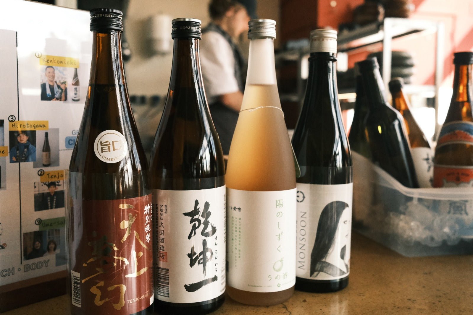 Row of premium artisan Japanese sake bottles with distinct labels, showcasing traditional design and small batch specialty.